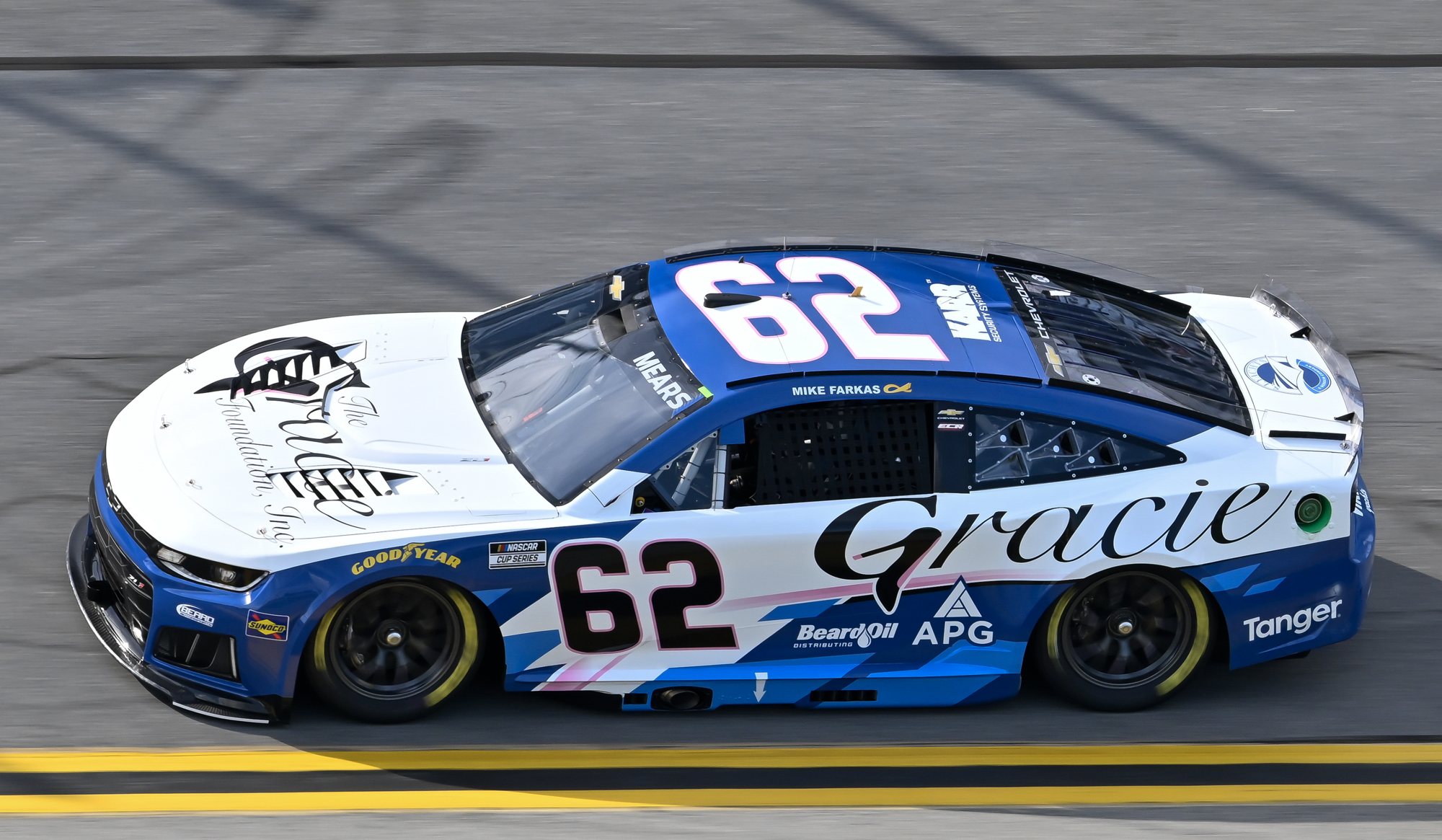 The blue and white No. 62 Chevrolet of Casey Mears, carrying The Gracie Foundation and Acrisure Protection Group logos, at speed at Daytona International Speedway
