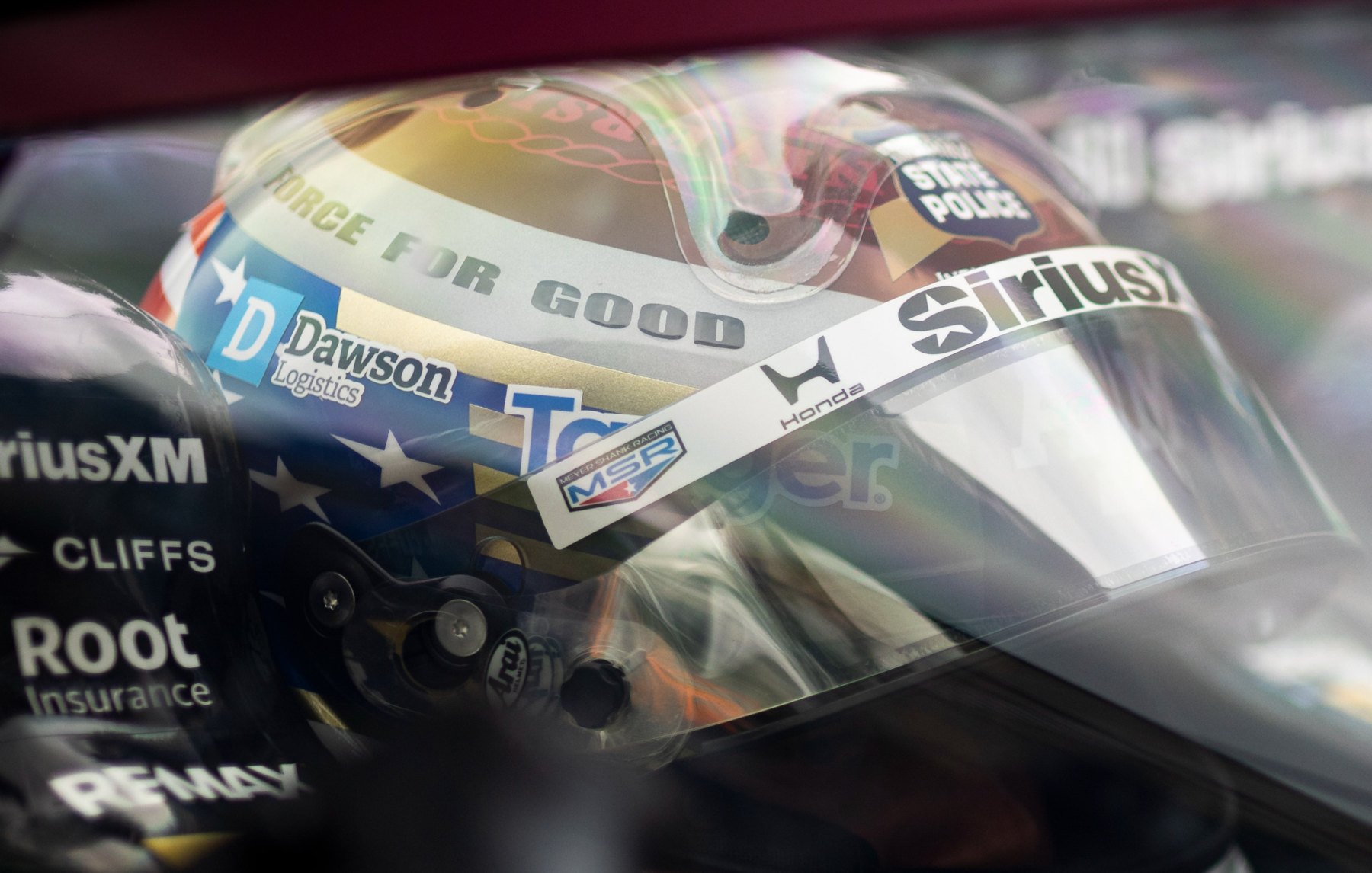 Close-up of Felix Rosenqvist’s helmet through the cockpit screen, showing the Dawson Logistics logo